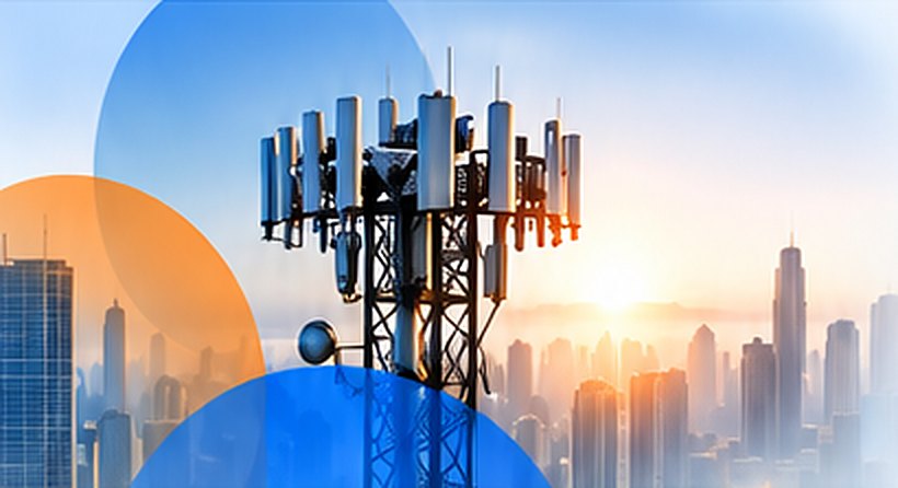 Cell tower over a city skyline at sunrise